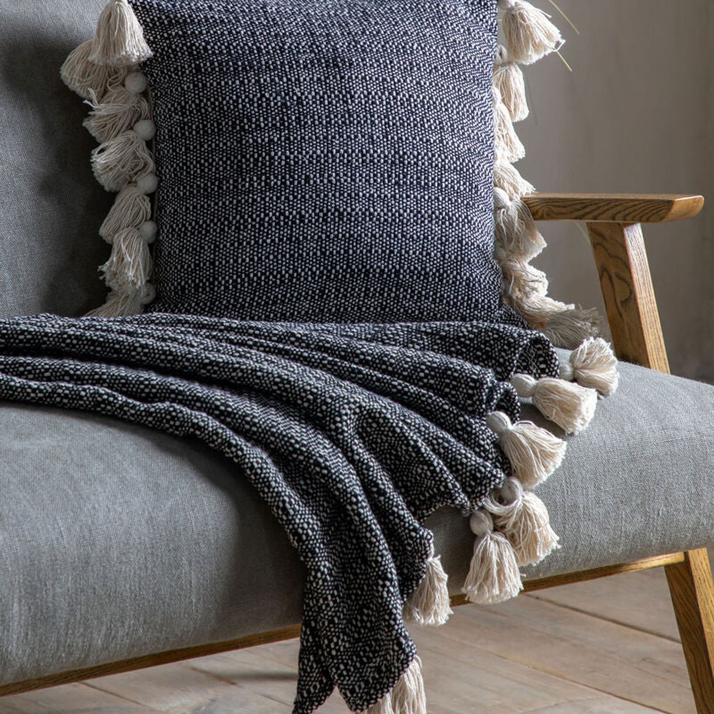 tish tassel throw in black - nineteen/seventy